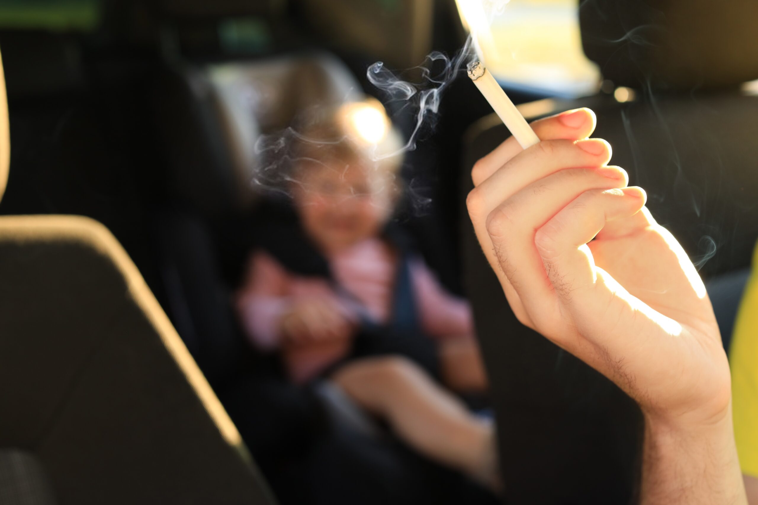 Mother,With,Cigarette,And,Child,In,Car,,Closeup.,Don’t,Smoke